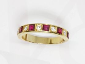 A ruby and diamond half eternity ring, yellow metal band unmarked, gross weight 4.4g, size O.