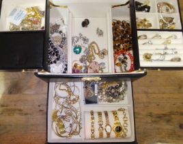 A black cantilever jewellery box with contents to include vintage jewellery, rings, watches,