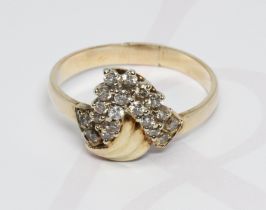 A diamond cluster ring, band unmarked, gross weight 3.4g, size N.