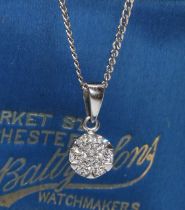 A diamond cluster pendant, seven round brilliant cut diamonds weighing approximately 0.30 carats,