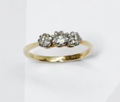 A three stone diamond ring, the stones weighing approximately 0.30 carats in total, yellow metal