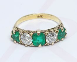A diamond and emerald ring, two old cut diamonds weighing approximate 0.53 & 0.58 carats, set