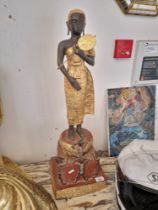 An Eastern cast metal and gilt decorated figure, height 73cm (approx).