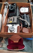 A box containing 3 cameras, small cased tripod, Weston Master III exposure meter, Vivitar 10 x 25