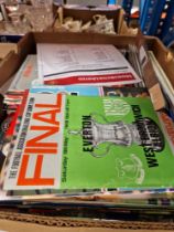 A box of assorted football programmes.