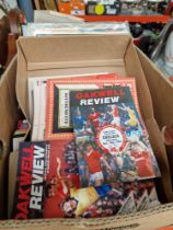 A box of LPs and 45s and a box of football programmes.