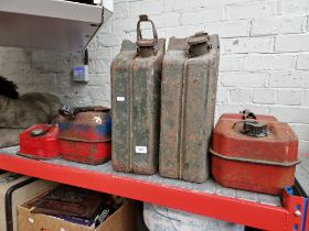 Two large petrol cans together with three small petrol cans