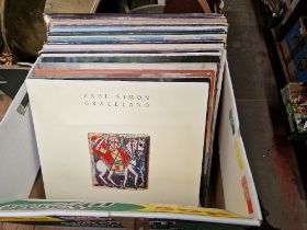 A box of rock LPs including Paul Simon Graceland, etc.