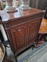 An early 20th century mahogany music cabinet.