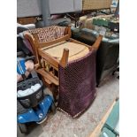 A pair of oak framed wingback armchairs with patterned upholstery.