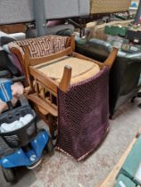 A pair of oak framed wingback armchairs with patterned upholstery.