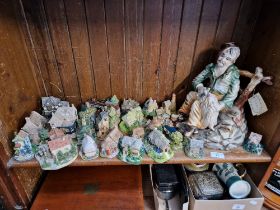 A large Capodimonte figure together with a good collection of cottages to include Lilliput Lane