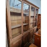 A large pitch pine cabinet bookcase, circa 1900, the locks stamped 'B Y S', height 242cm and width