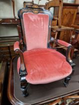 A Victorian ebonised and burr walnut armchair.