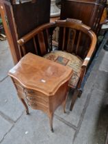 A French three drawer kingwood bedside cabinet and an Edwardian tub chair.