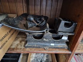 A set of antique cast iron scales with weights.