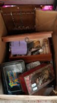 A box containing a collection of souvenir spoons, costume jewellery, coins etc