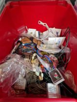 A box of costume jewellery, watches and pin badges.