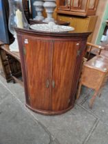 A Georgian mahogany corner cabinet together with an oak occasional table.