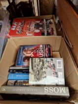 Two boxes of motor racing books.