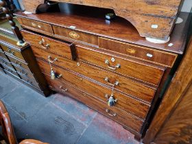 A George III mahogany chest of drawers, standing on ogee bracket feet.