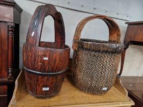 A wooden well bucket and a basket.