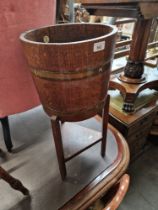 A brass bound oak planter on stand by R. Alister & Co Ltd, Dursley, England.