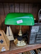 A vintage metal and green glass desk lamp.