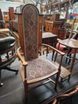 An Edwardian Arts & Crafts inlaid mahogany high back armchair.