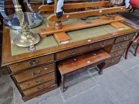 An oak twin pedestal partner's desk with tooled leather top.