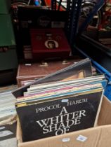 A box and a case of vinyl LP records and a case of singles, various artists and genres.