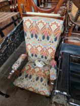 An early 20th century mahogany armchair with Arts & Crafts style upholstery.