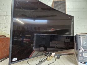 A 55" Samsung curved TV with remote.