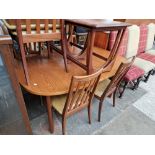 A mid 20th century G Plan teak extending dining table and six chairs.