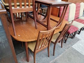 A mid 20th century G Plan teak extending dining table and six chairs.