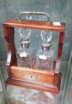 A pair of liqueur decanters with hallmarked silver collars, Birmingham 1990, together with tantalus.