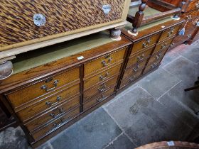 A pair of oak filing chests with tooled leather tops.