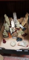 A collection of oriental carved soapstone figures and ornaments.