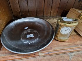 A Borrowdale hand beaten stainless steel bowl together with a brass and glass carriage clock with