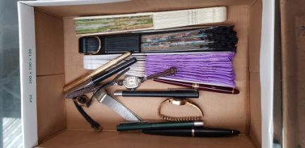 A mixed lot comprising ladies watches, three fans and various pens including Parker, etc.