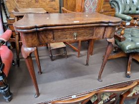 A George II walnut and oak concertina-action card table, the interior playing surface having burr