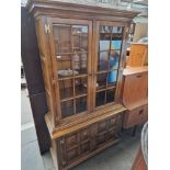 An aged oak cabinet bookcase.