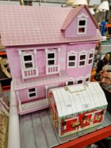 A dolls house with furniture and barn with animals.