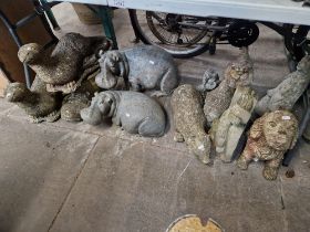 Twelve small garden ornaments comprising of 2 hippos, a dog & otters etc.