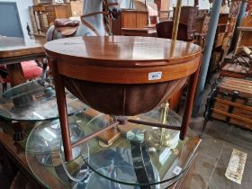 A mid 20th century teak sewing table and contents.