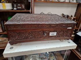 An Anglo Indian carved hardwood box with key.