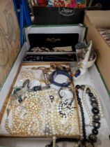 A box containing costume jewellery, vintage watches and a Staffordshire pottery pocketwatch holder.