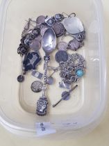 A collection of silver jewellery and coins.