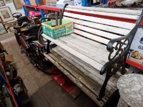 A cast metal garden table together with two cast metal garden benches.