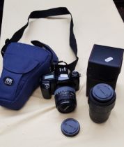 A Canon EOS 1000F SLR camera and two lenses.